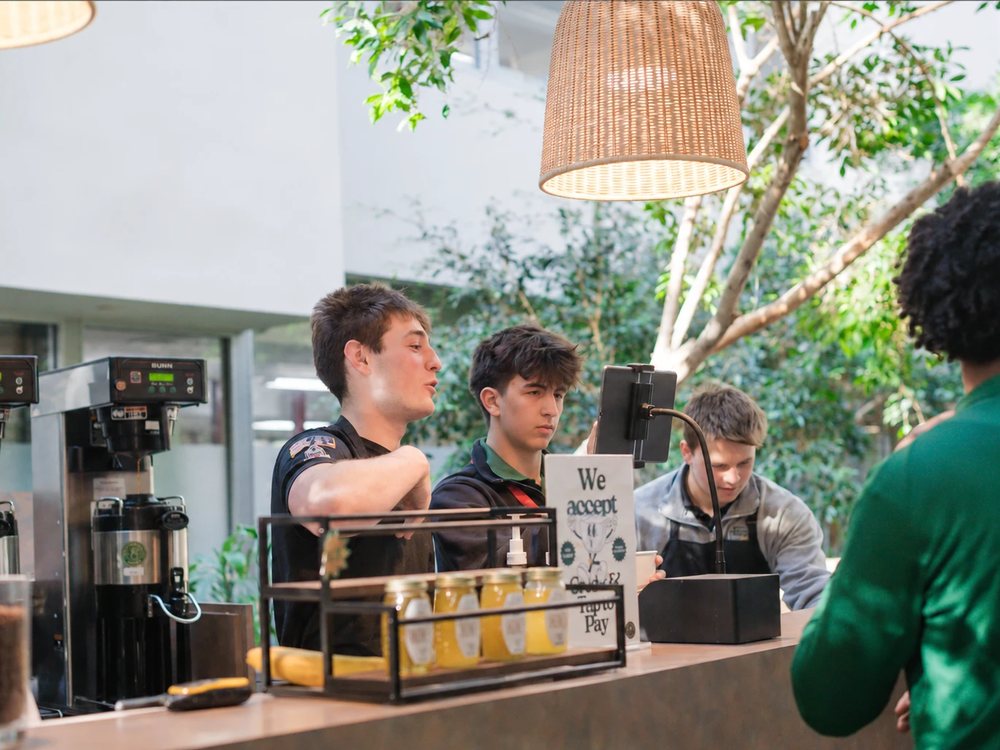 Students running the Brother Joe's Coffee counter at Saint Patrick High School