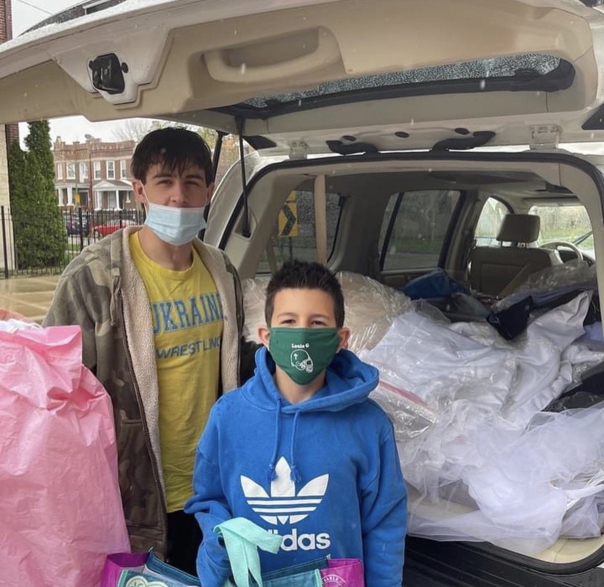 Rocco in a face mask helping collect donations for a food pantry during the coronavirus