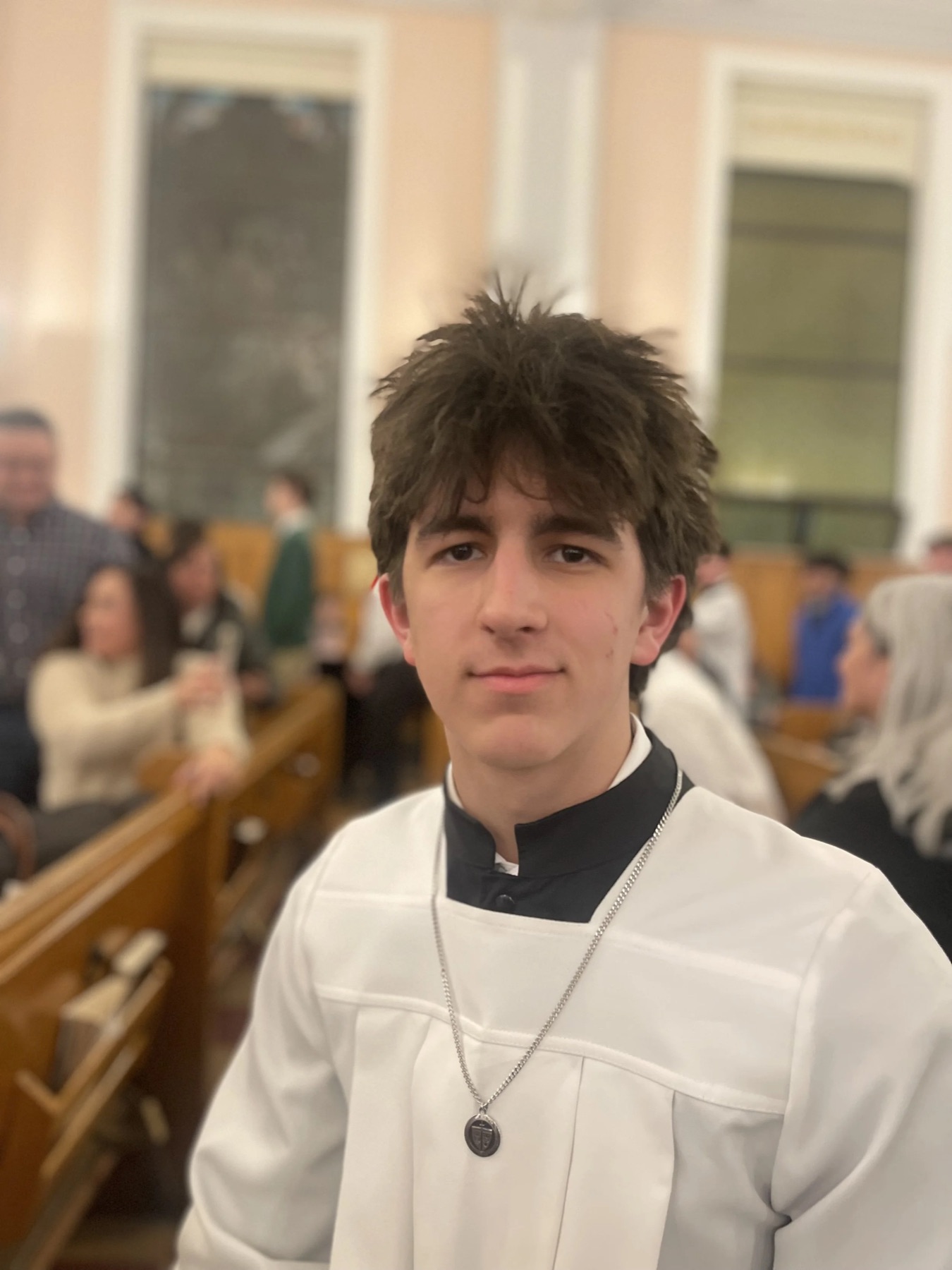 Rocco in a server's cassock and surplice at church