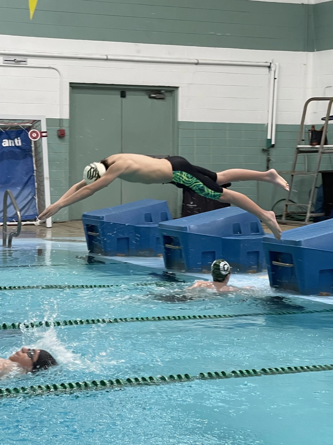 Rocco diving off the block for varsity swim